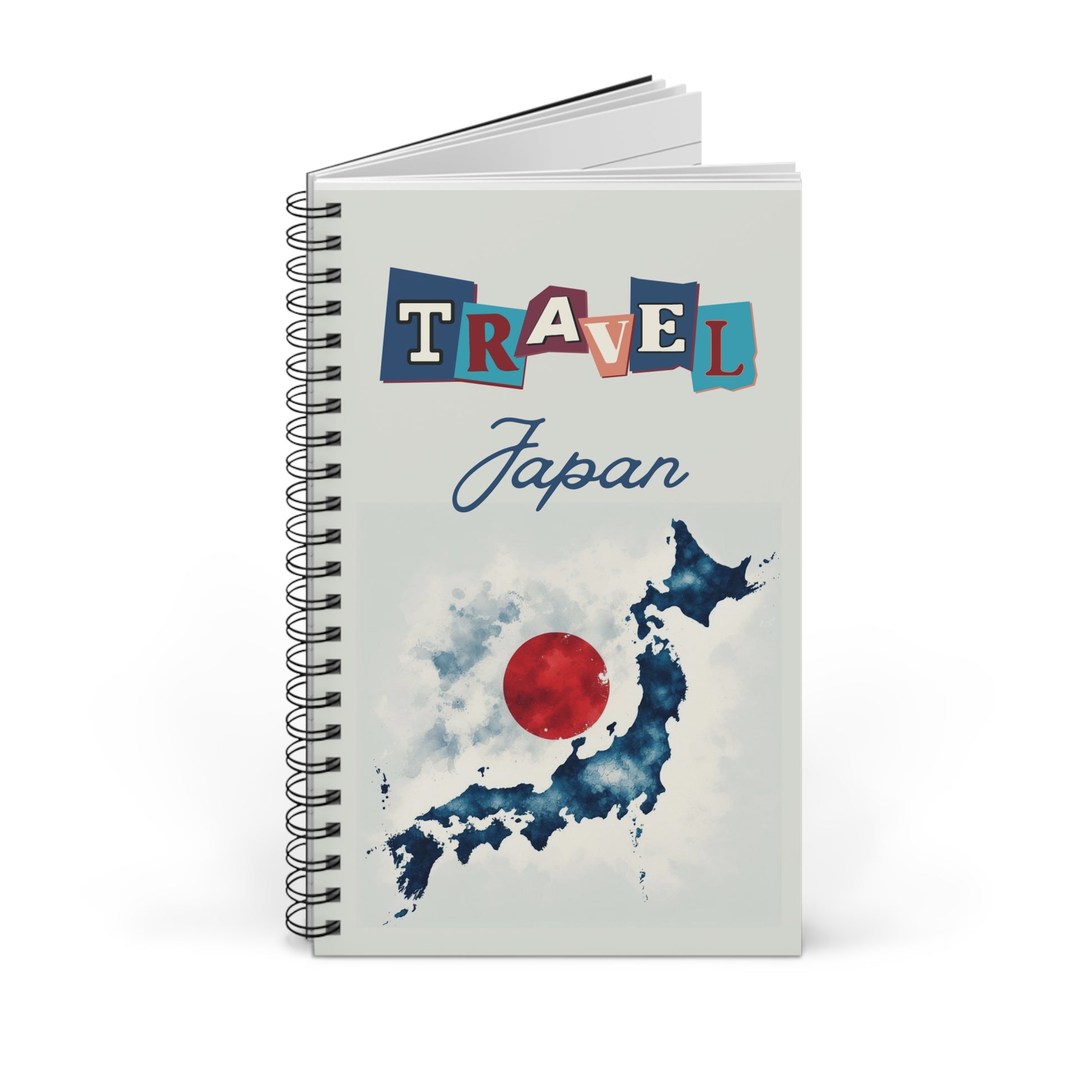 The Prodigi Travel Japan Notebook features a spiral-bound design with vibrant Travel lettering and Japan in cursive on the cover. Below is a watercolor map of Japan with a red circle like the Japanese flag, perfect for capturing your adventures. Available in blank, lined, or dot grid formats.