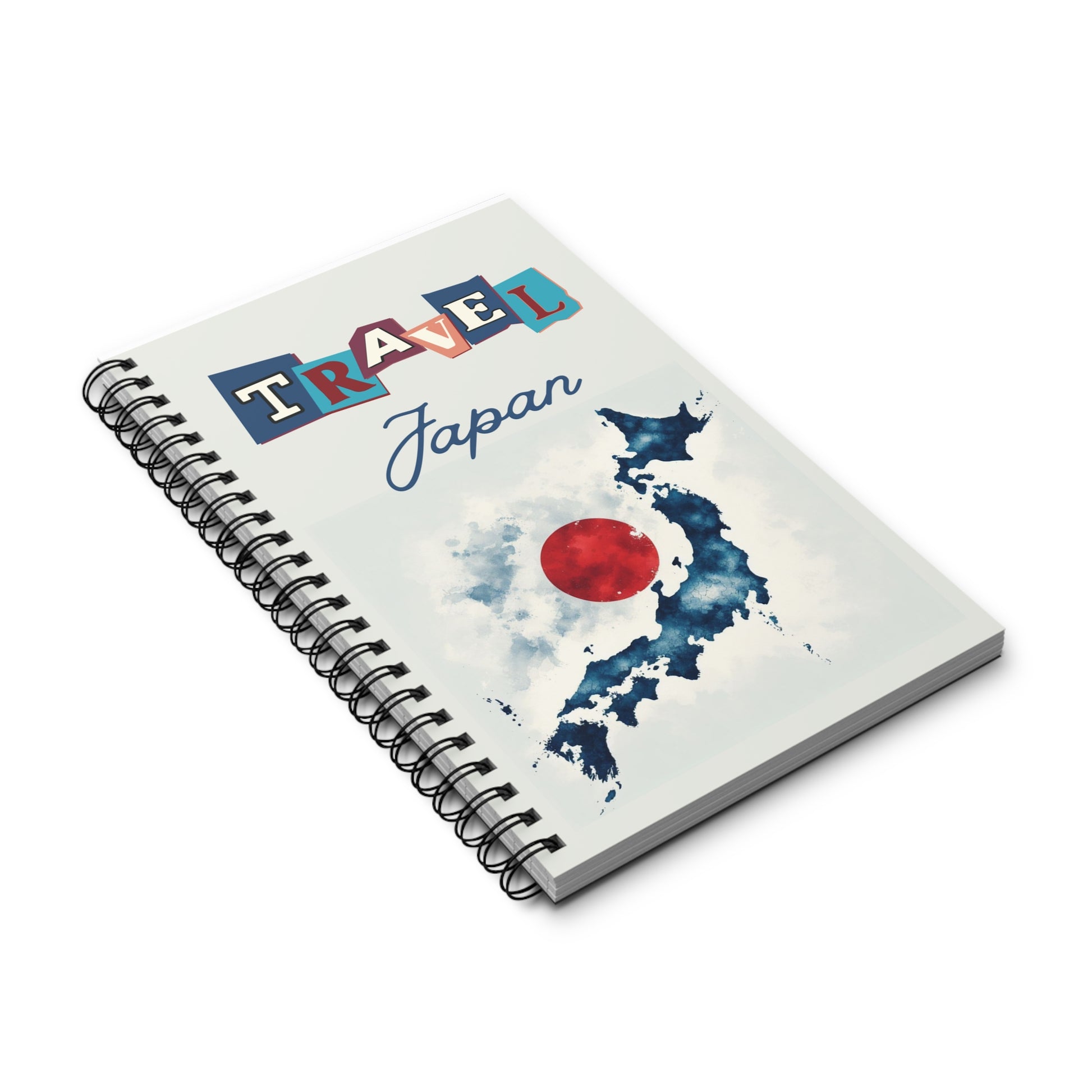 The Prodigi Travel Japan Notebook is a spiral-bound travel journal available in blank, lined, or dot grid. It features a blue watercolor artistic map of Japan with a red circle resembling the Japanese flag, ideal for your travel journaling adventures.