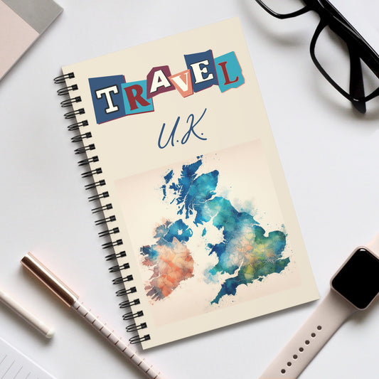 Prodigis spiral-bound UK-themed travel notebook features a vibrant watercolor map of the U.K. with TRAVEL in bold letters on the cover, surrounded by a pen, glasses, and smartwatch on a white surface—perfect for documenting your British cultural adventures. Choose your page design!.