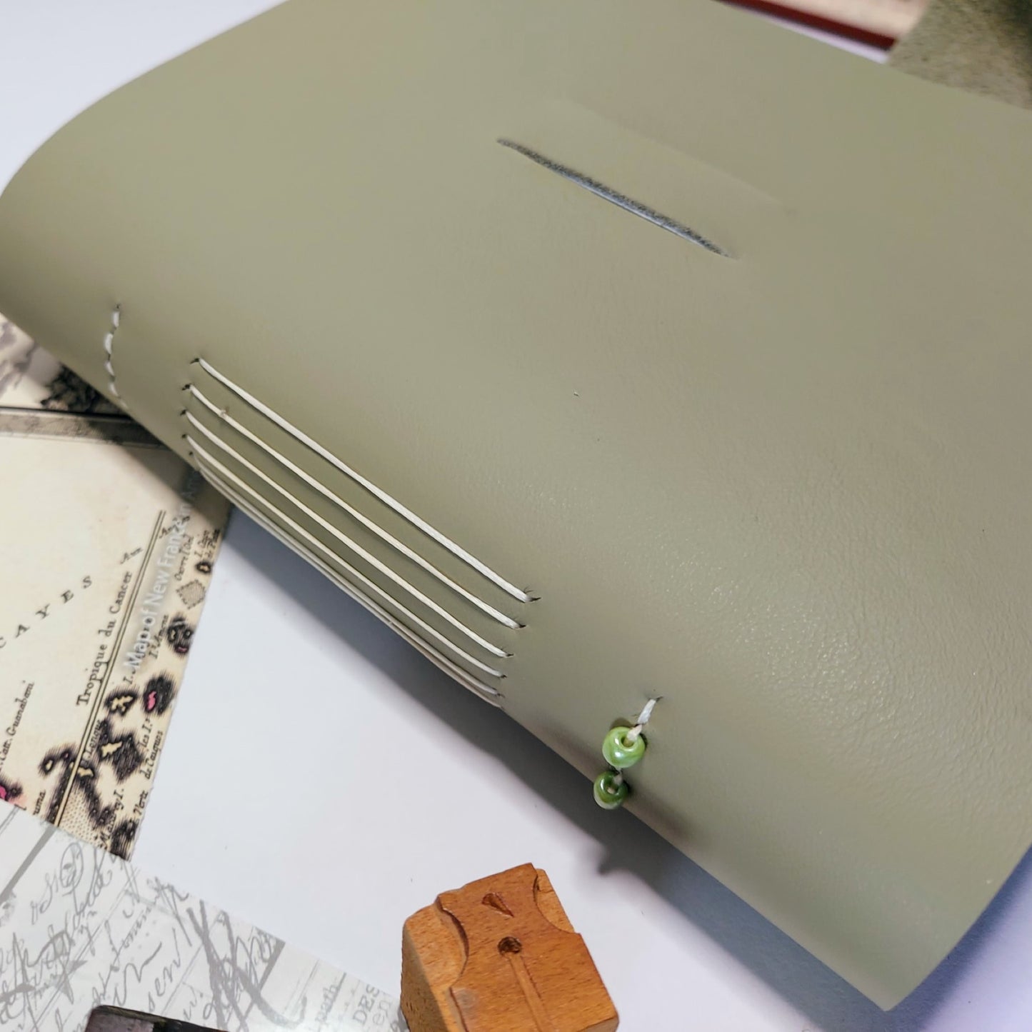 Olin leather with longstitch and green glass beadsive green travel journal