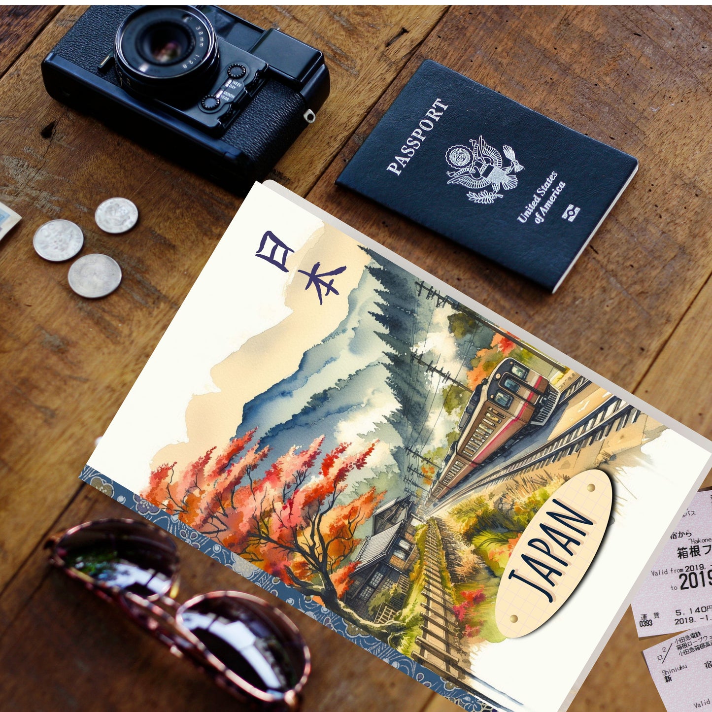 Passport with Japanese design, camera, passport, and sunglasses on a wooden surface