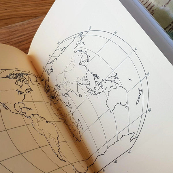 Centre spread of a blank world map inside a personalised leather travel journal