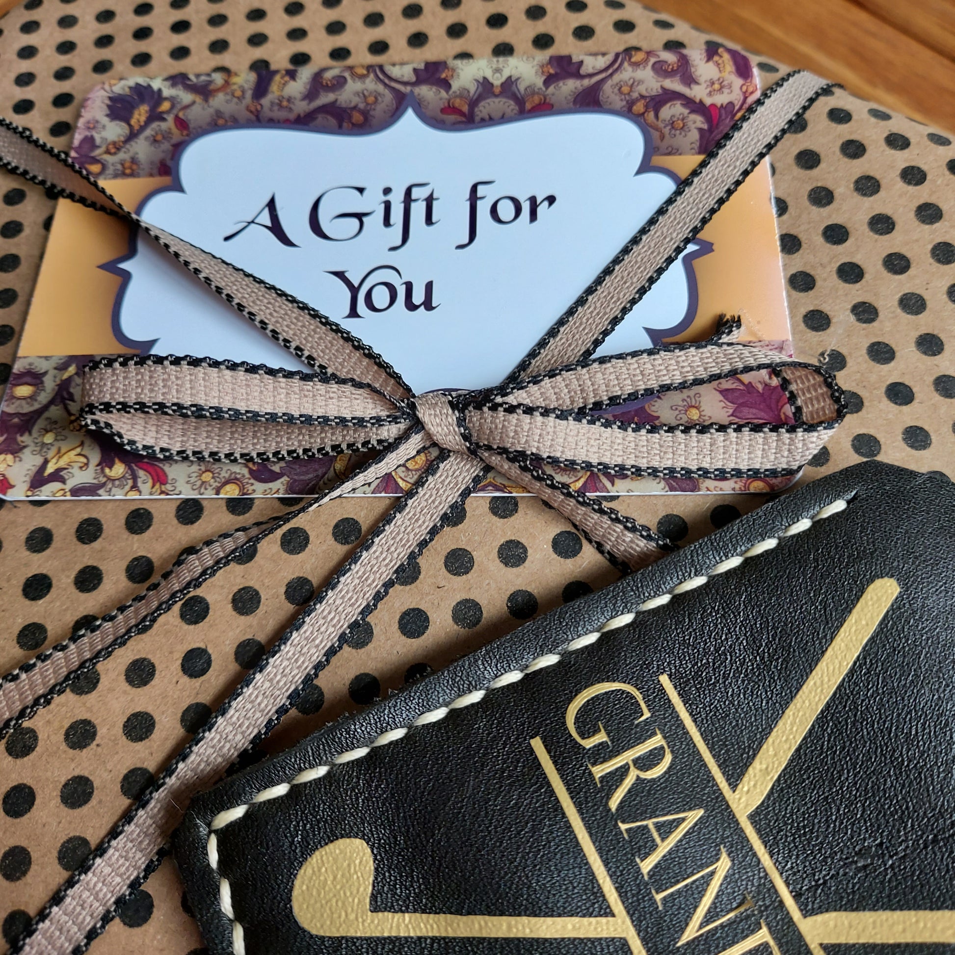 Golf Gift Set wrapped in spotted gift paper tied with ribbon