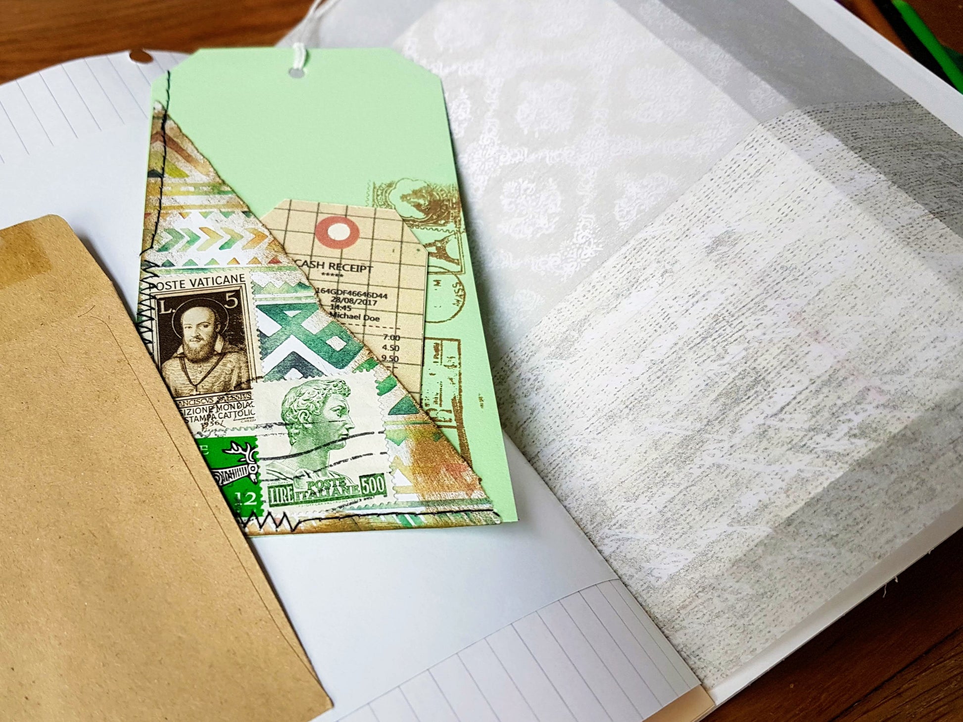 Hand stitched tag with tuck spot, slipped behind fixed brown envelope showing handwriting paper for inspiration