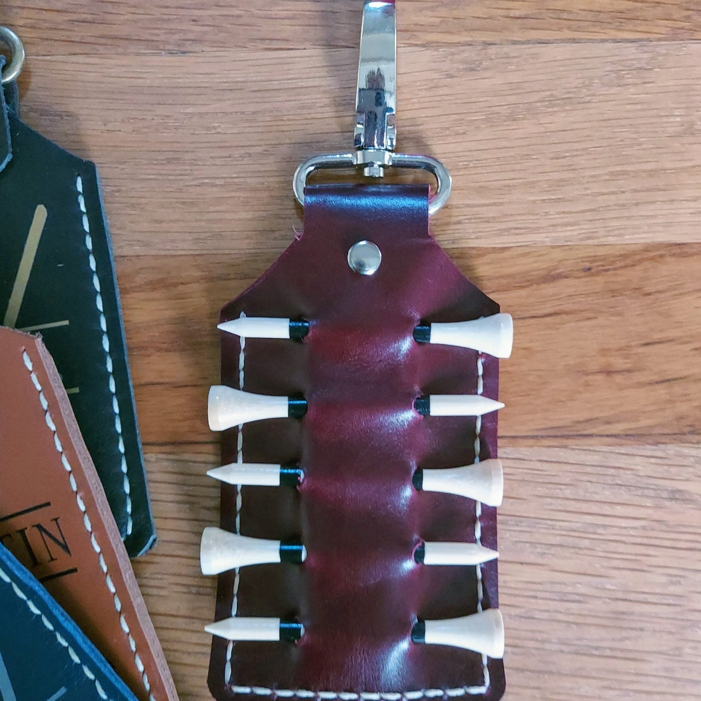 leather golf tee holder clip with bamboo tees and silver clip