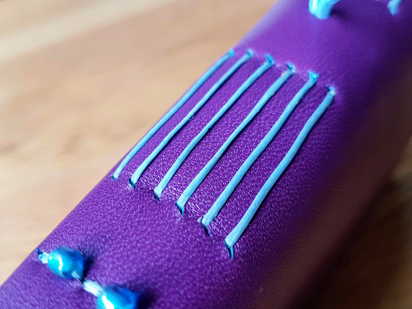 Purple leather travel journal with pale blue hand stitched spine with glass beads