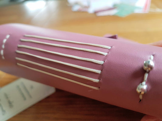 hand stitched spine on leather travel journal
