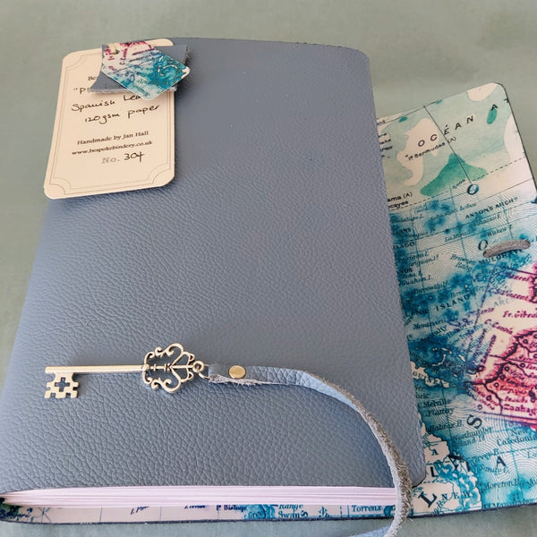 light blue leather trifold travel journal with silver key trim