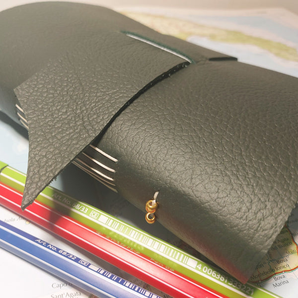 Dark green leather travel journal with pockets
