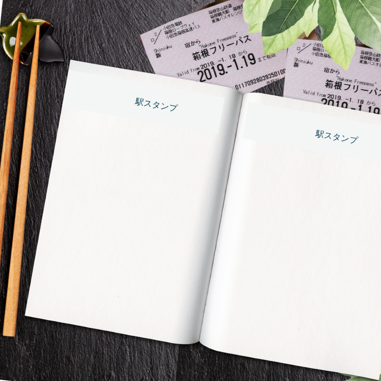 open notebook pages for collecting EKI stamps, japanese characters at the top of each page with japan chopsticks and japan rail tickets