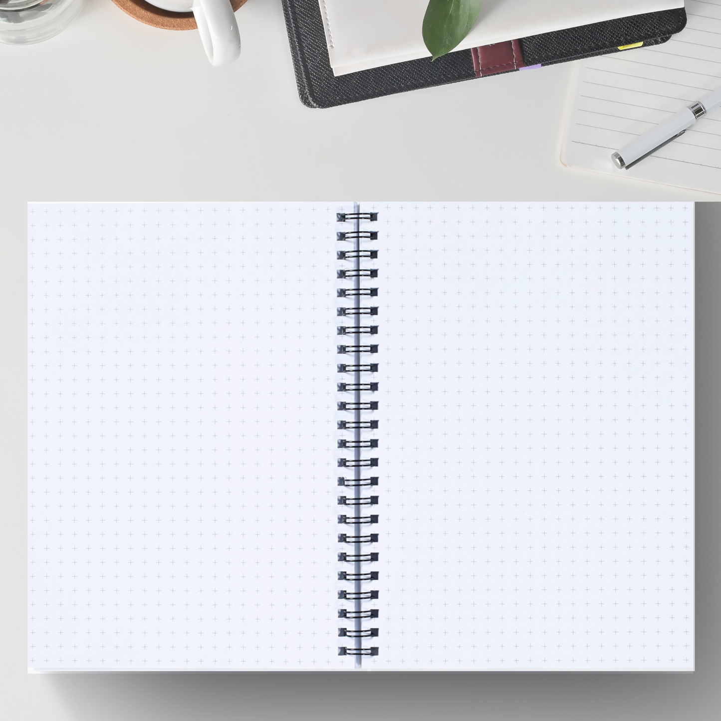 Open spiral bound notebook with graph grid pages