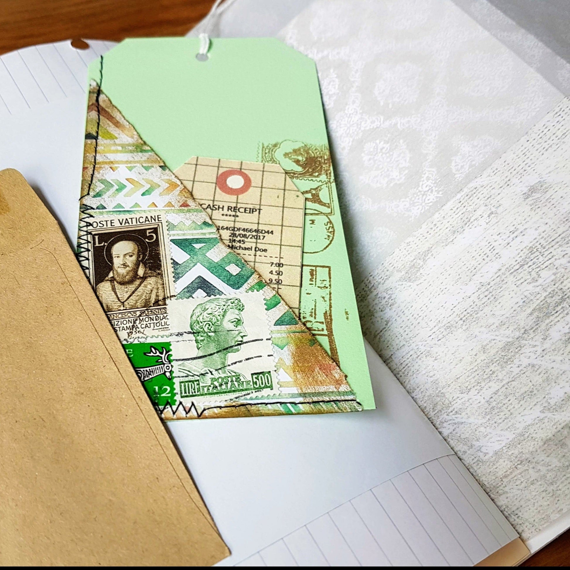 handmade tag for junk journal with scrapbook paper and postage stamps