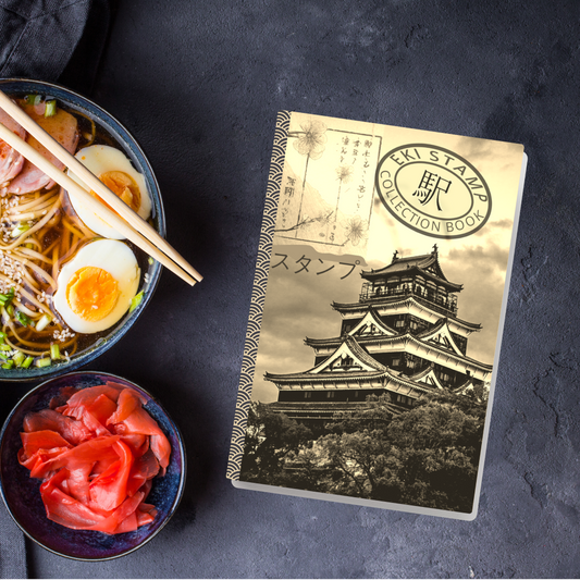 Eki Stamp collection book with sepia japanese temple and characters alongside red and blue passports and rail tickets