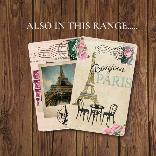 two travel journals for Paris.  Both feature the eiffel tower - one in a vintage photo, the other behind paris cafe table and chairs