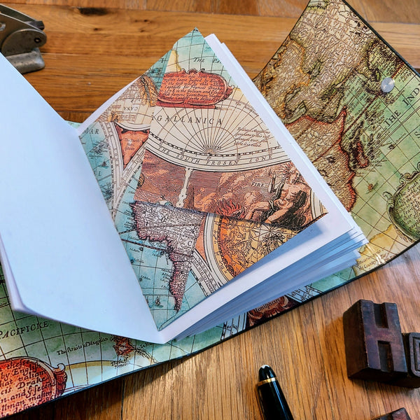 Vintage map images inside a personalised leather travel journal