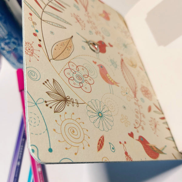 inside cover of the journal is lined with a cute bird and abstract flower design