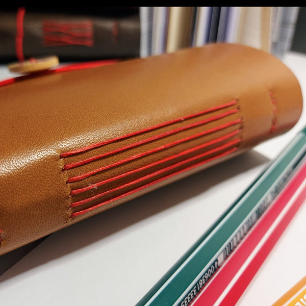 handbound journal showing long stitch spine using red waxed thread