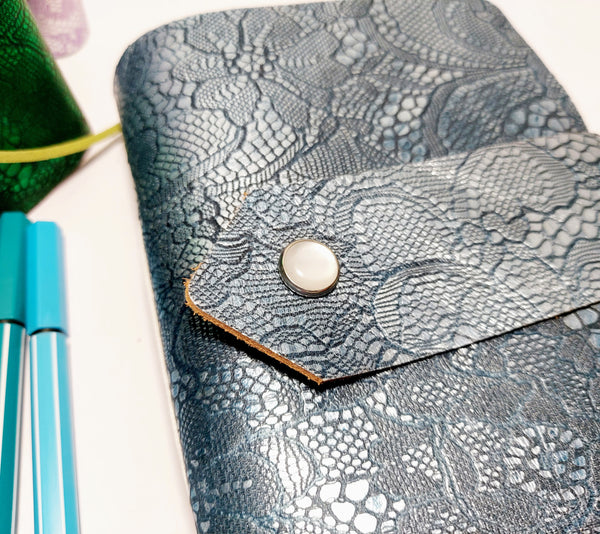 close up of petrol blue embossed leather mixed paper notebook journal