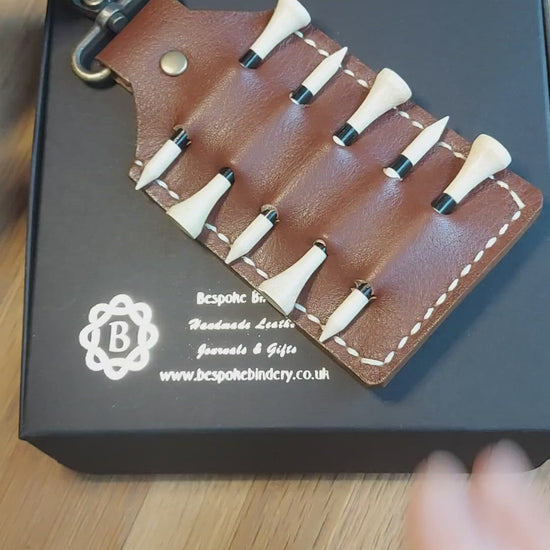 video showing brown personalised leather golf tee holder to clip on a golf bag