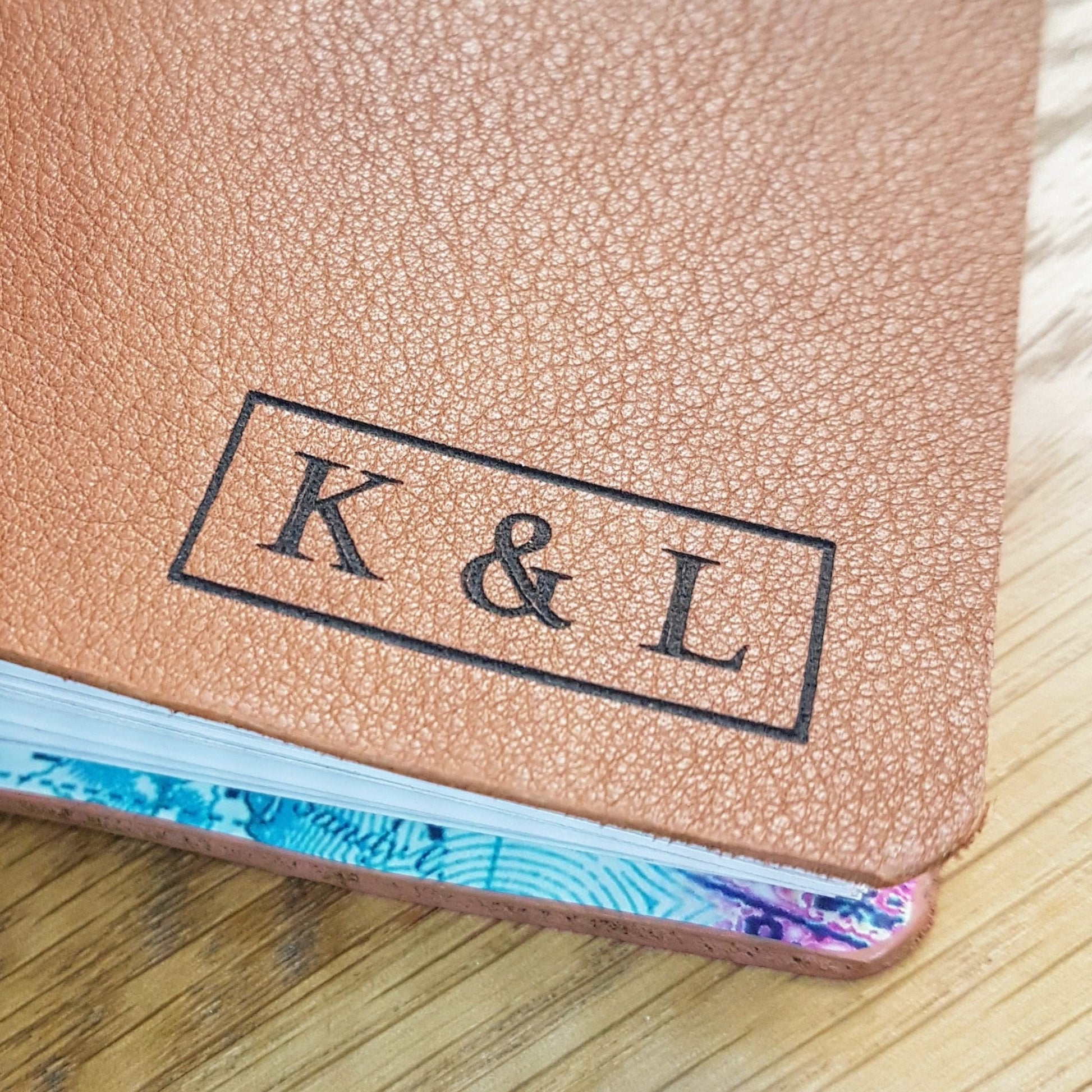 add laser engraved  initials to the front of a travel journal