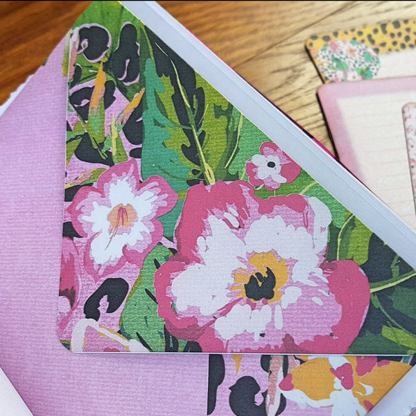large floral design on flap of journaling envelop and matching cards in the background