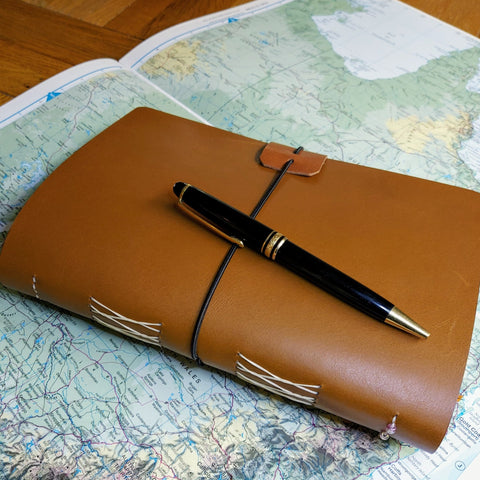Leather Journal in Golden Brown Leather fastens with elastic loop.  Themed for Australia and showing Mont Blanc Pen