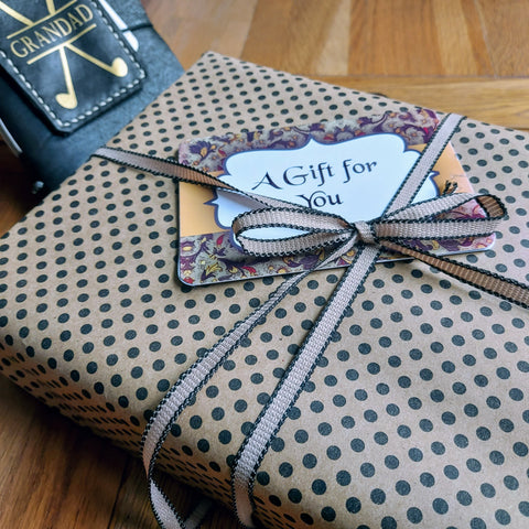 Bespoke Bindery gift wrap in Kraft paper and black dots trimmed with ribbon