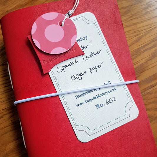 red Leather Golfing journal for ladies with white elastic closure and hand written tag