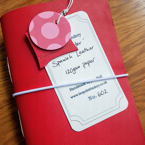 red Leather Golfing journal for ladies with white elastic closure and hand written tag