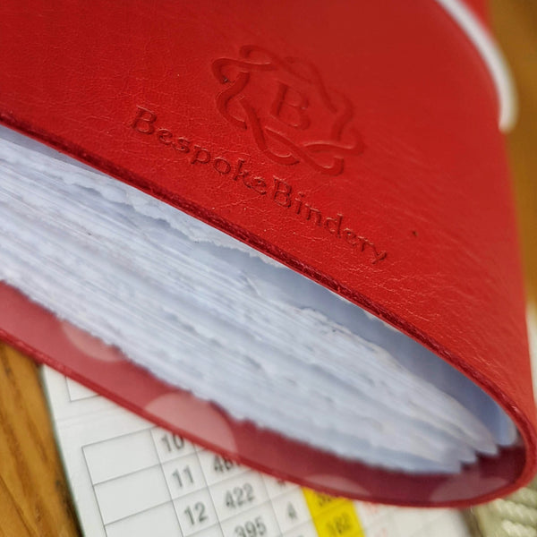 bespoke Bindery embossed logo on rear of red leather golf journal notebook