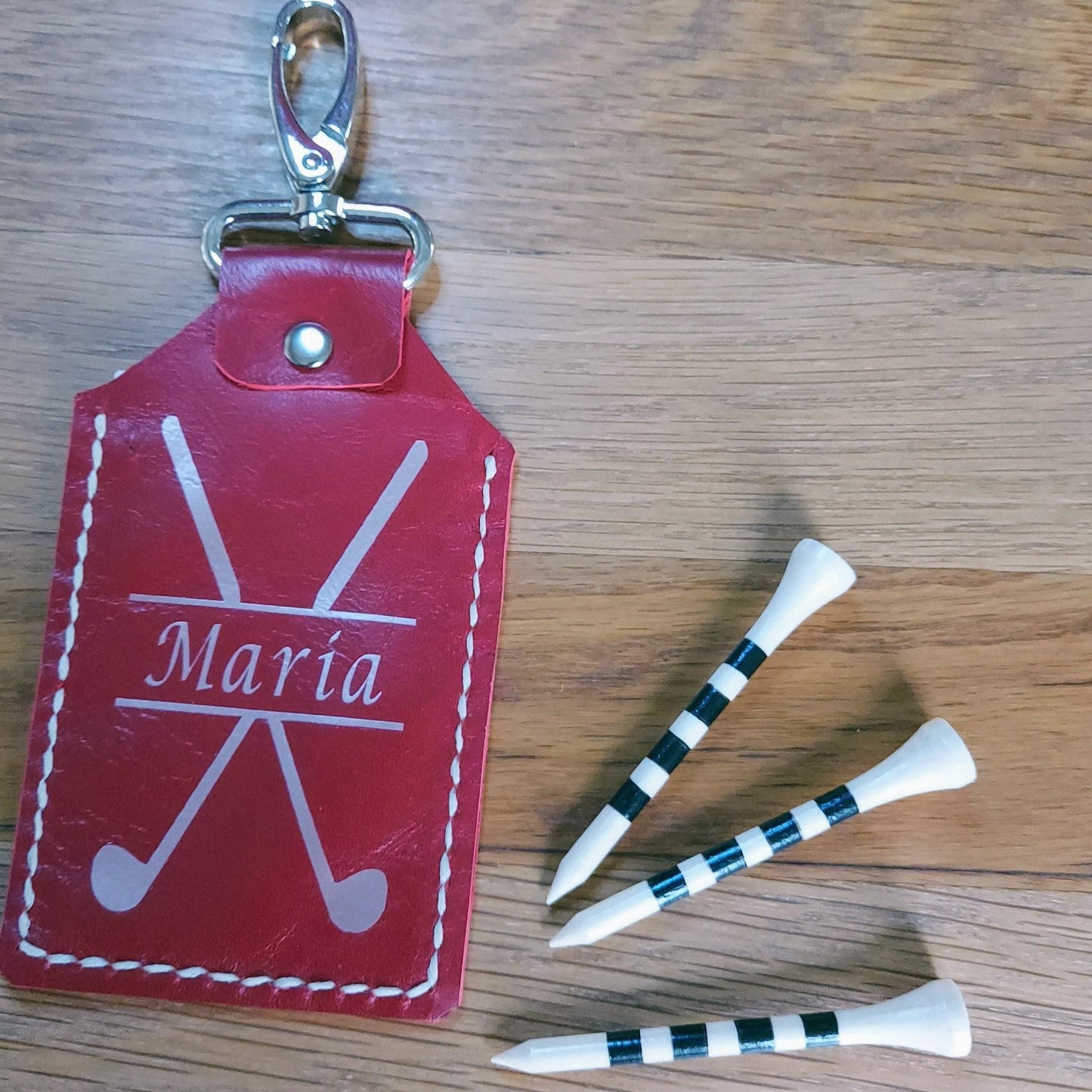 handstitched red leather golf tee holder with rose gold metallic personalisation showing 3 bamboo golf tees