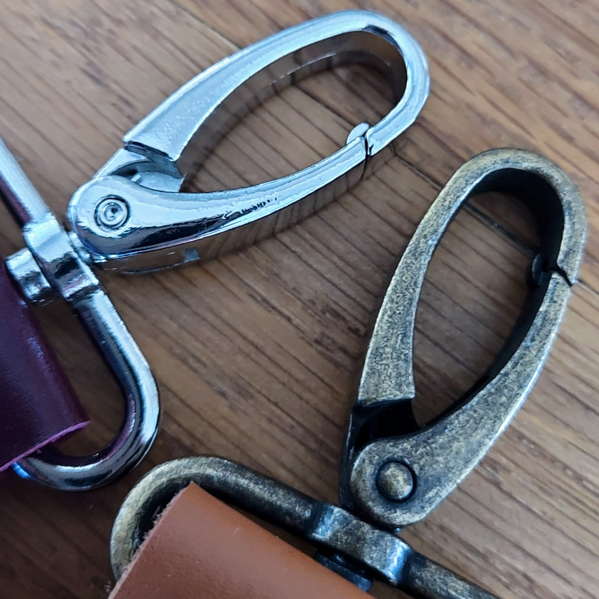 silver nickel and antique brass lobster clips on leather golf tee holders