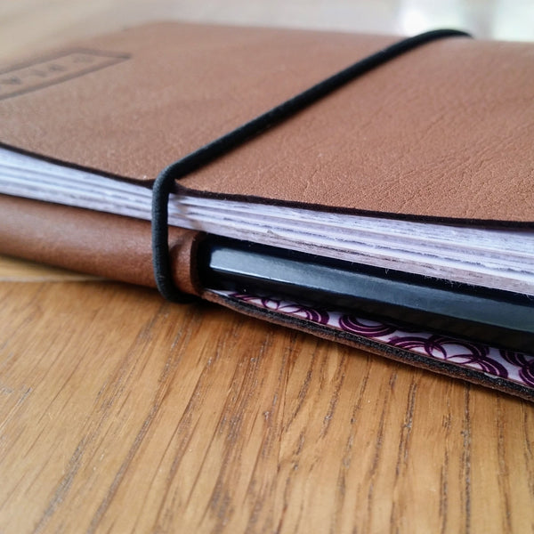 Leather golf journal with pencil pocket and elastic fastener loop