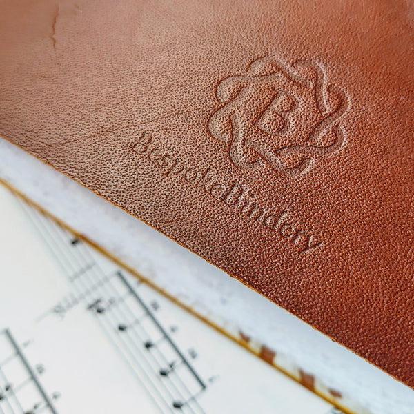 Bespoke Bindery logo branded into the leather on reverse of music journal