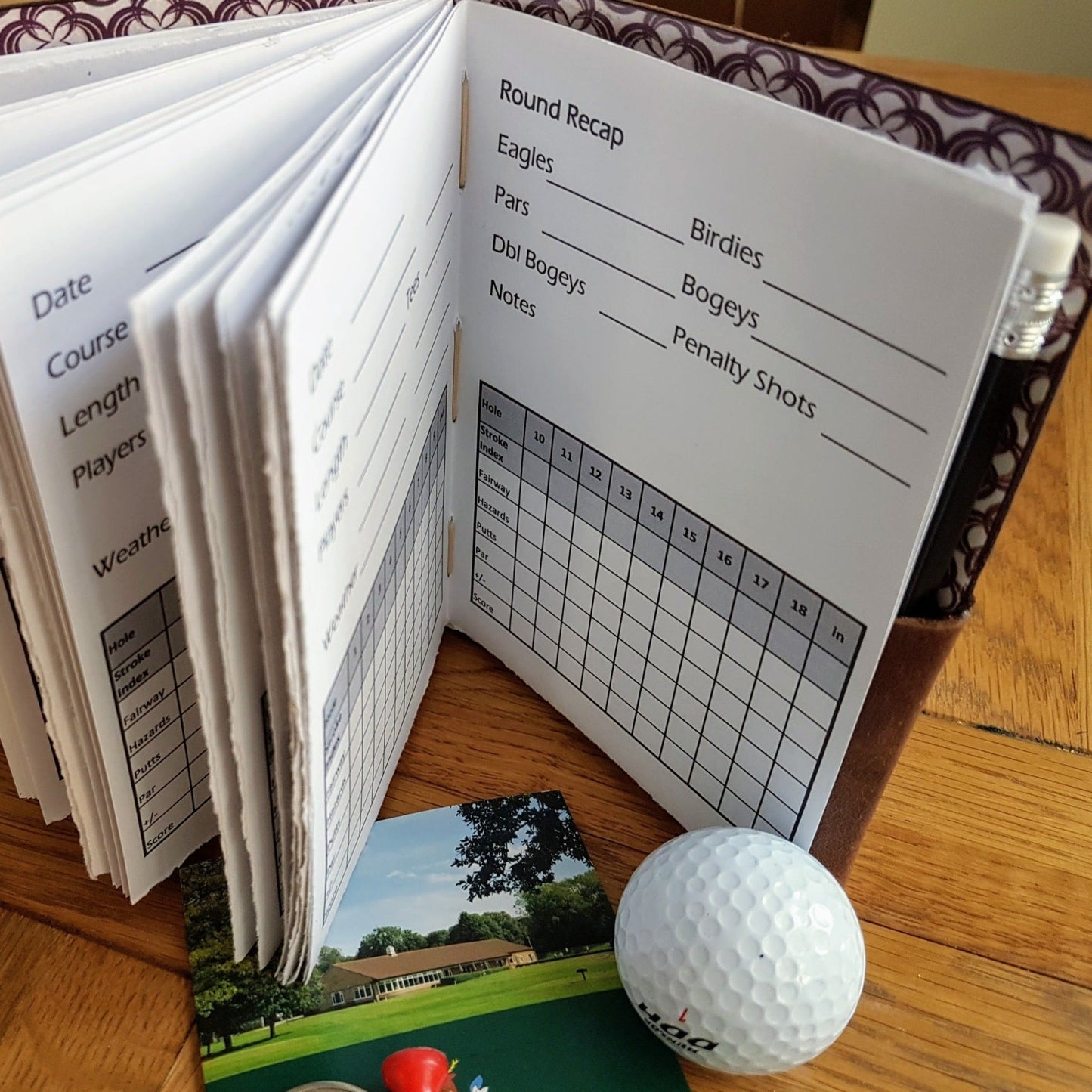 Golf Performance Tracker log in brown leather showing inside pages to record your golf score