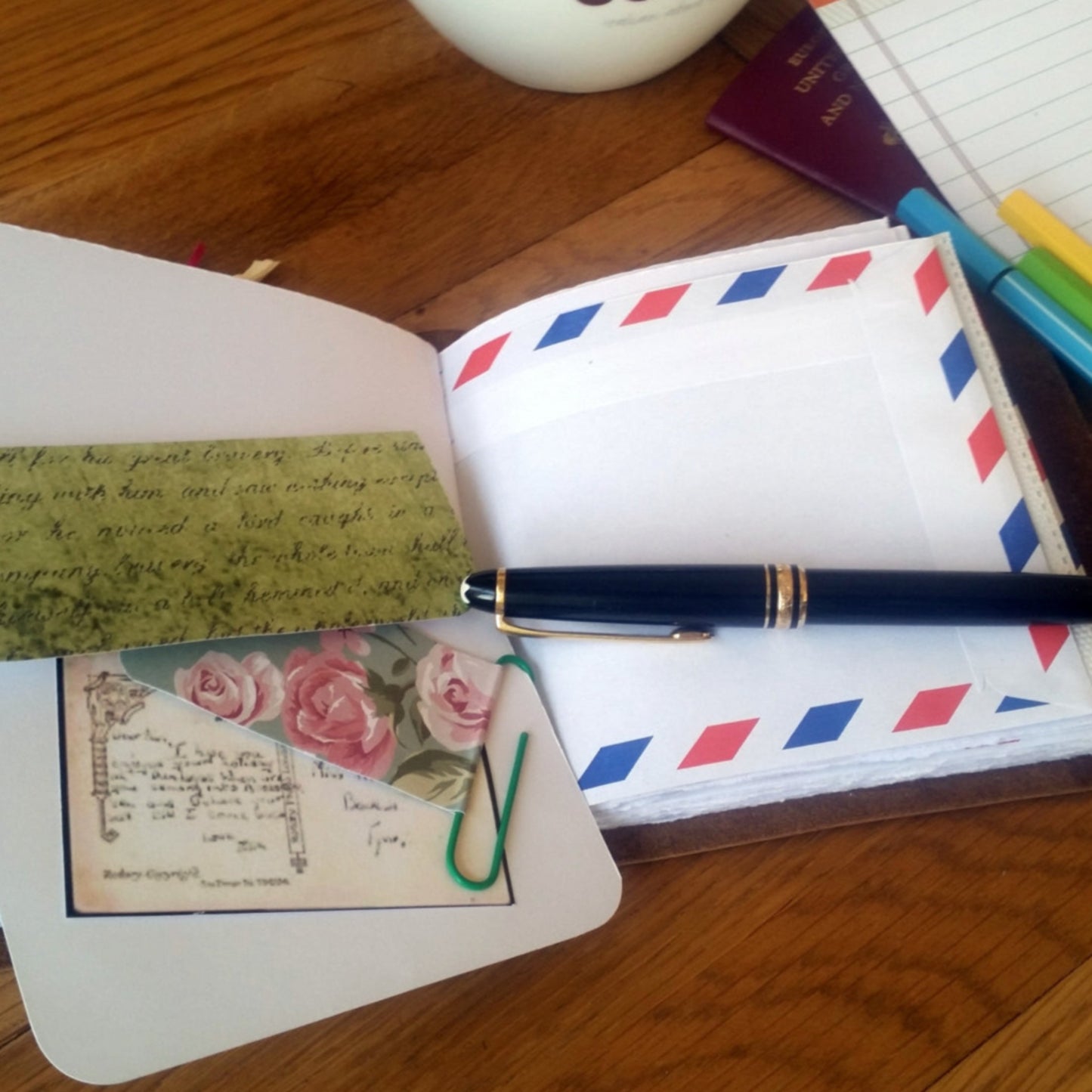 Small leather travel journal with airmail envelope pockets by bespoke bindery