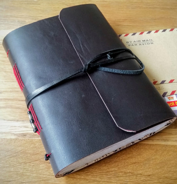 Dark leather wrap over cycling journal with beaded spine