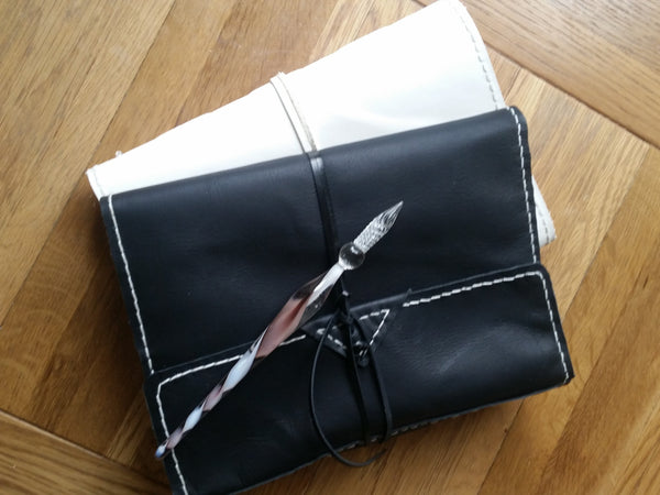 black and white leather portfolio cases showing hand stitching around the edge