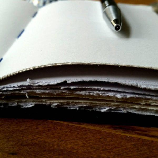 Leather journal showing hand torn pages