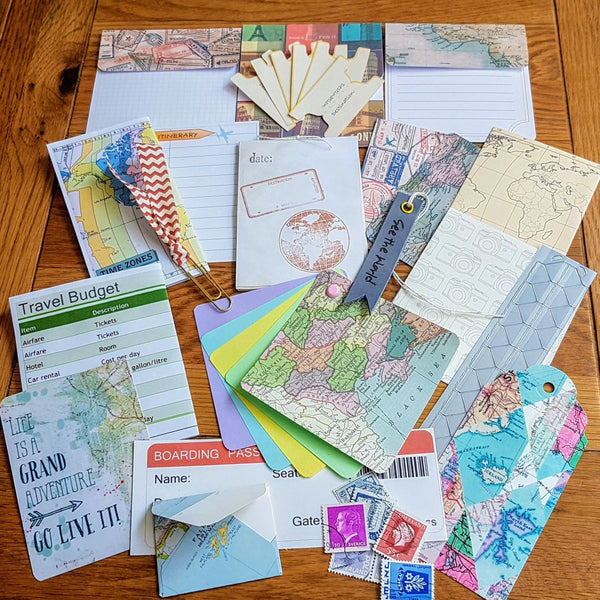 Mixed travel extras featuring travel related journal cards, stamps, map images, photo corners